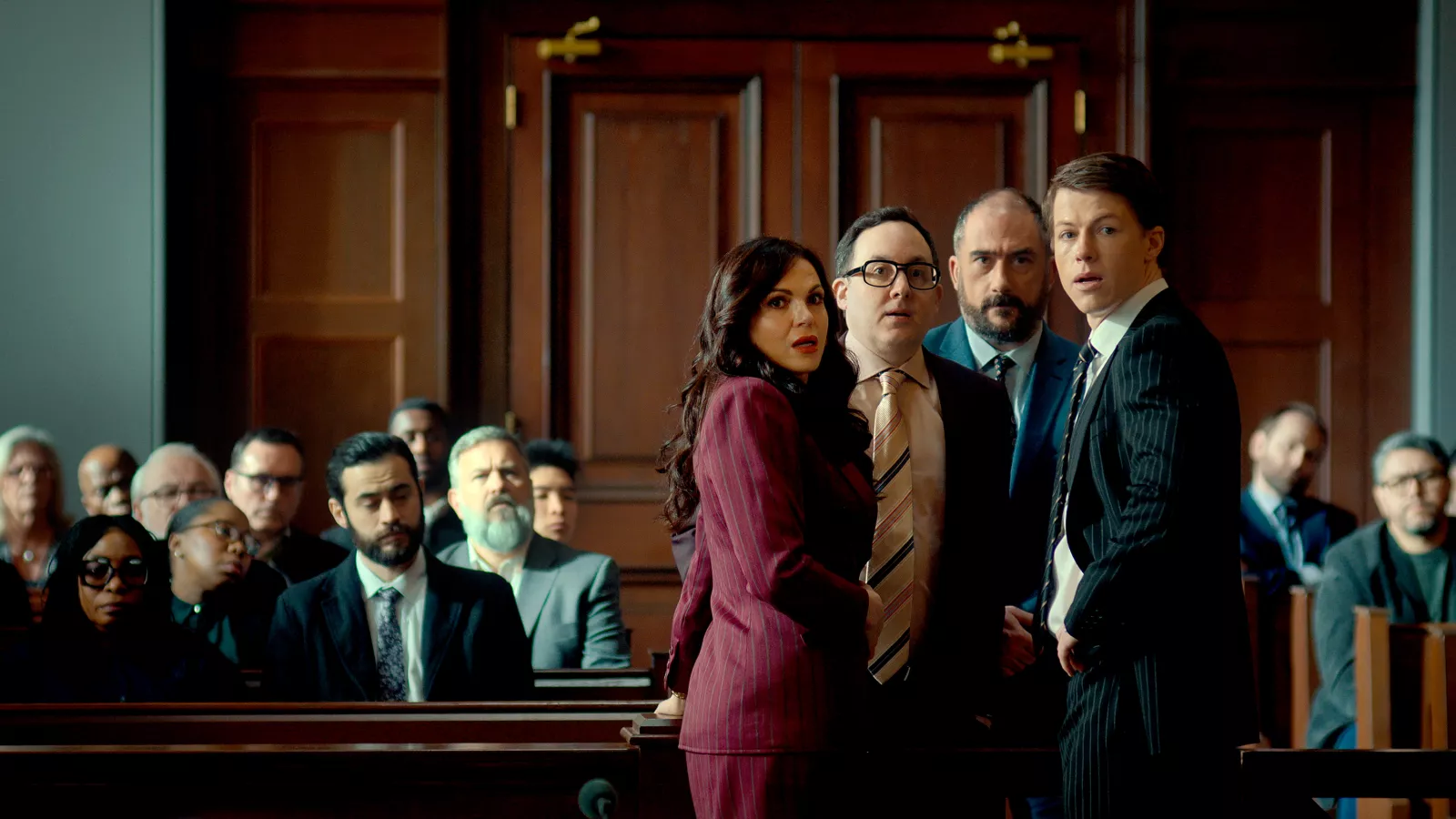 Episode 110 -- (l-r) Lana Parrilla as Jocelyn “Bruiser” Stone, P.J. Byrne as Deck Shifflet, Oisin De Lange as Butch, Milo Callaghan as Rudy Baylor in The Rainmaker. Photo Credit: © 2025 USA Network/ VERSANT MEDIA. All Rights Reserved