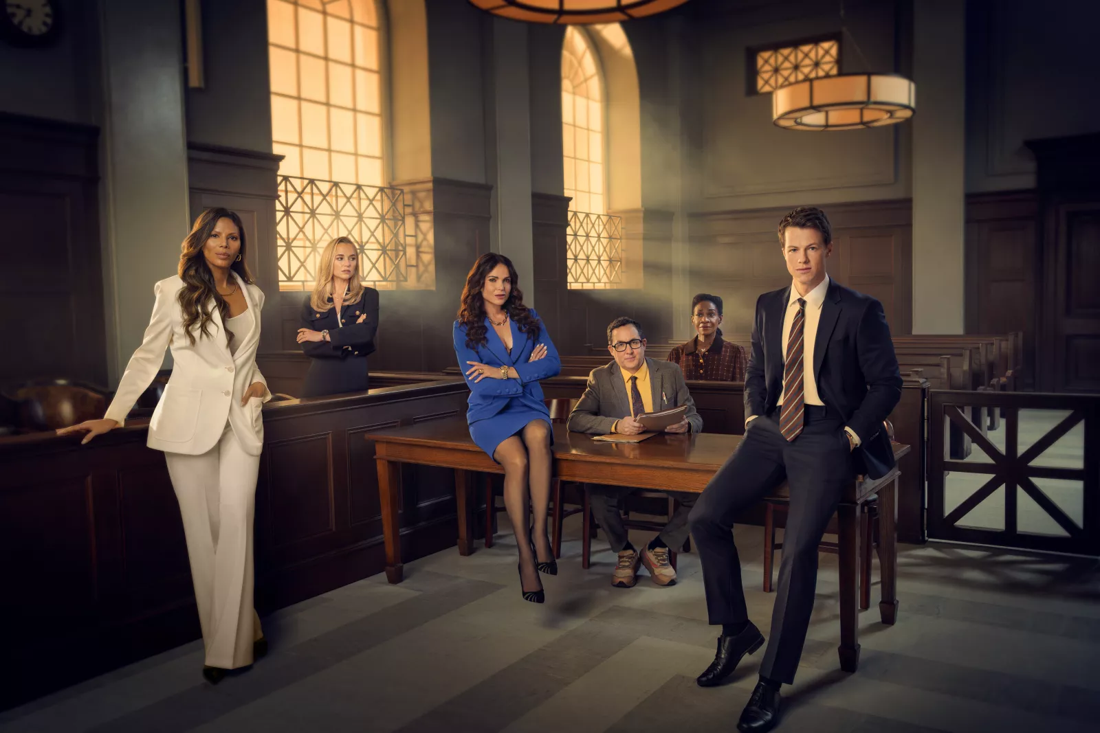 (L-R) Merle Dandridge as Amanda Vonn, Madison Iseman as Sarah Plankmore, Lana Parrilla as Jocelyn "Bruiser" Stone, PJ Byrne as Deck Shifflet, Karen Bryson as Dot Black and Milo Callaghan as Rudy Baylor in Season 2 of The Rainmaker on USA Network.  